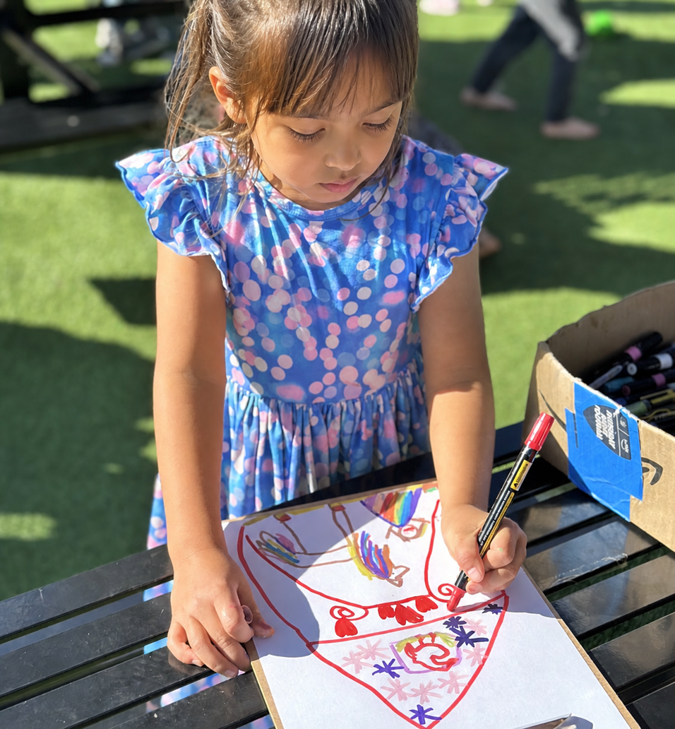 A child carefully adjusting cargo on a homemade sleigh