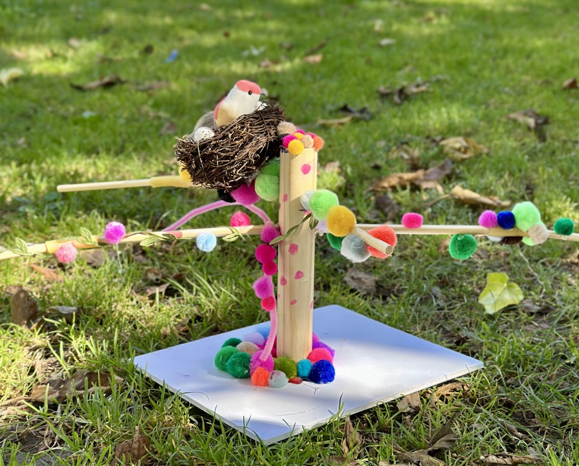 A completed fighter tree model with a jointed branch protecting a tiny nest.