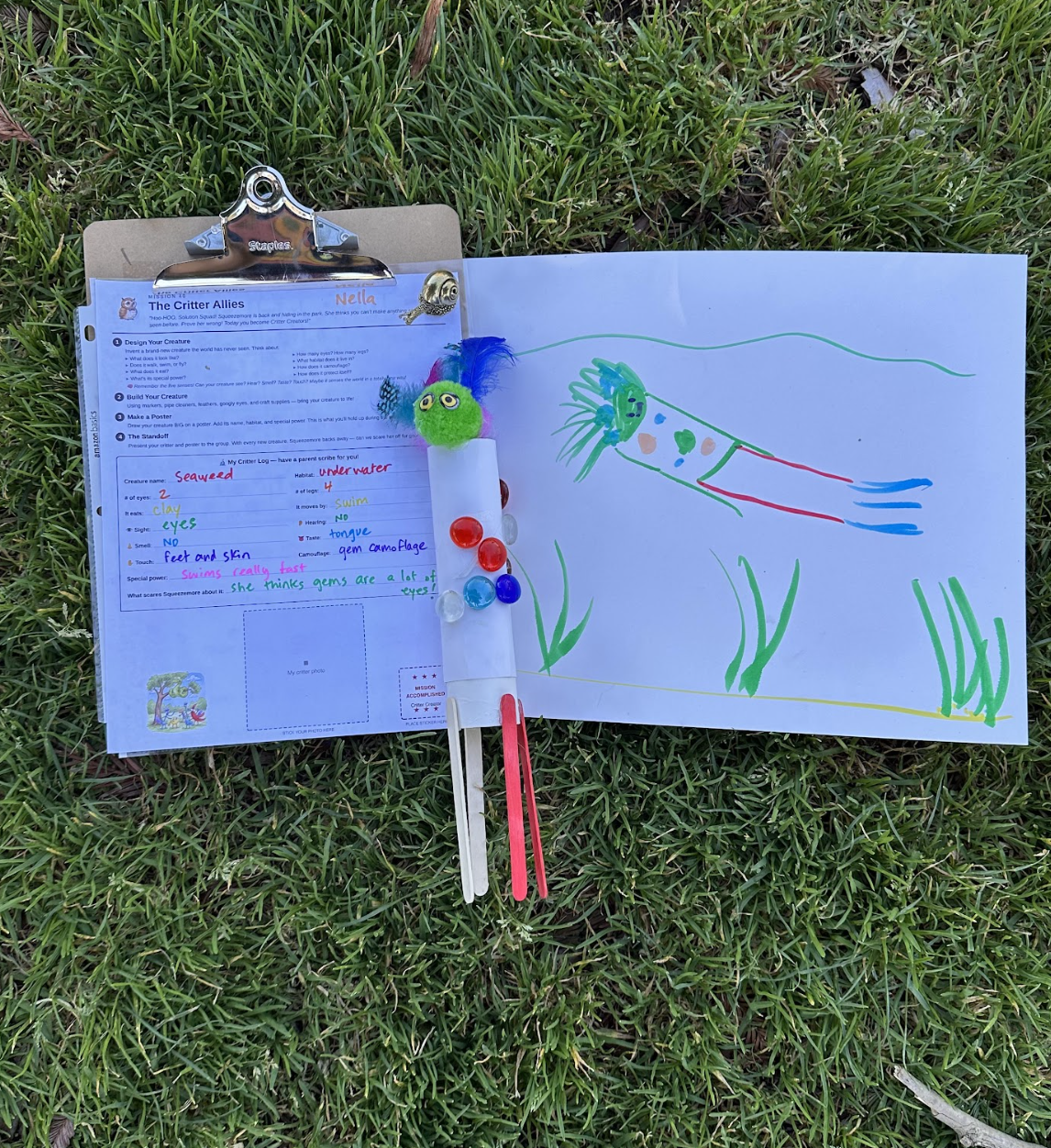 A child holds up a finished meter-stick launcher with a decorated cup.