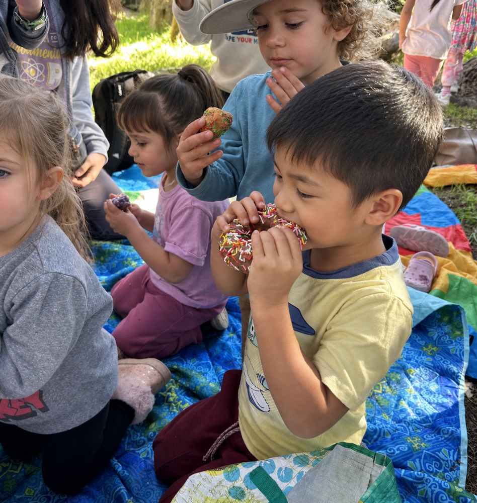 A child carefully reading a small thermometer tucked inside a wool-lined sanctuary.