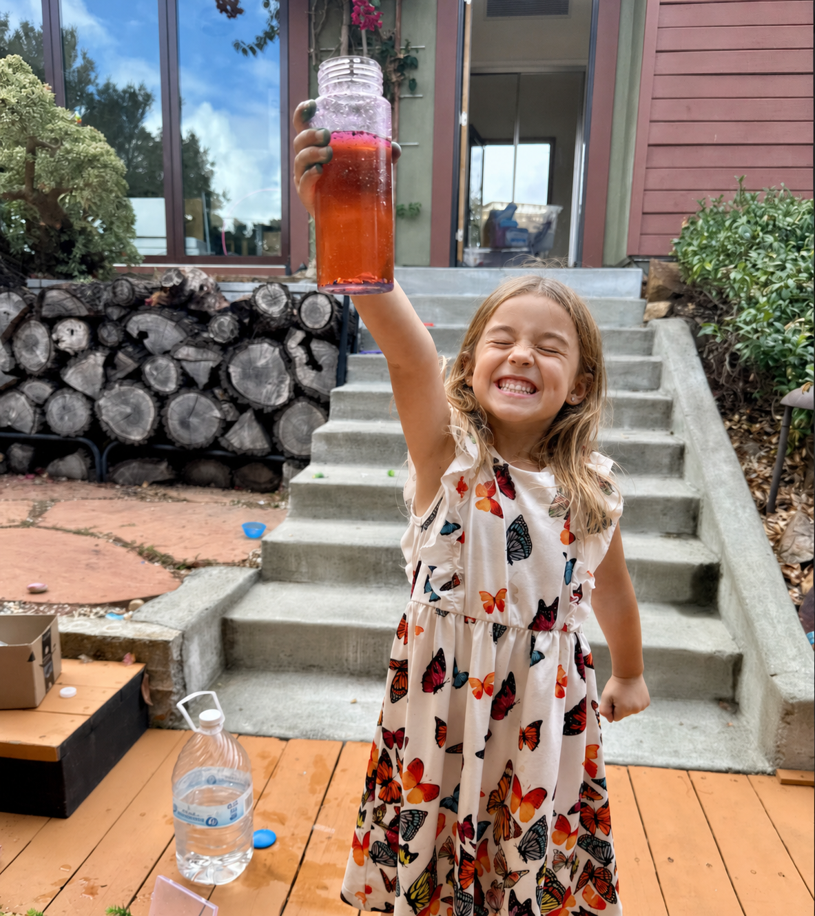 A child proudly holding up something she made during a pod gathering